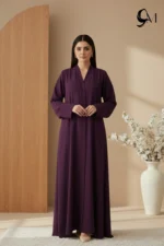 Soft Contrast Framing: Pair with a lavender, dusty rose, or cream hijab to brighten the model's face and elegantly highlight the rich purple tones of the garment. Luminous Accents: Use silver or pearl jewelry and nude pointed-toe heels to create a polished, sophisticated finish that balances the depth of the eggplant shade.