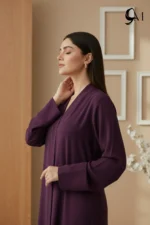 Soft Contrast Framing: Pair with a lavender, dusty rose, or cream hijab to brighten the model's face and elegantly highlight the rich purple tones of the garment. Luminous Accents: Use silver or pearl jewelry and nude pointed-toe heels to create a polished, sophisticated finish that balances the depth of the eggplant shade.