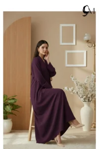 Soft Contrast Framing: Pair with a lavender, dusty rose, or cream hijab to brighten the model's face and elegantly highlight the rich purple tones of the garment. Luminous Accents: Use silver or pearl jewelry and nude pointed-toe heels to create a polished, sophisticated finish that balances the depth of the eggplant shade.